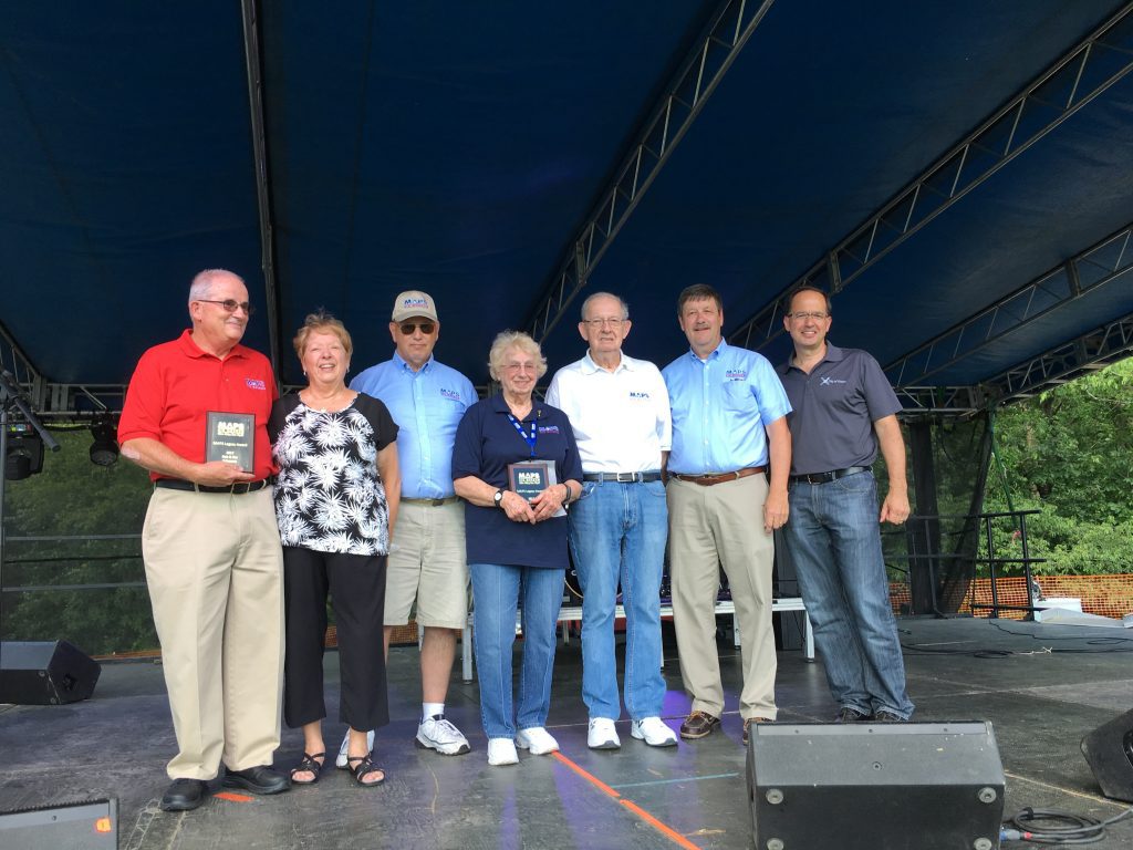 Pictured from left to right: Bob and Pat Schwartz, Rick Hamlet, Mary Ann and Jim Cameron, Kim Kovesci, and Green Mayor Gerard Neugebauer